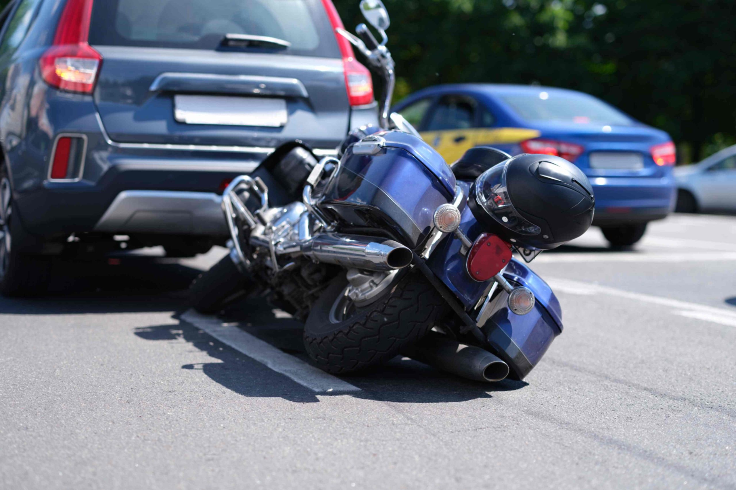 jpeg optimizer blue motorcycle lying road near car closeup scaled