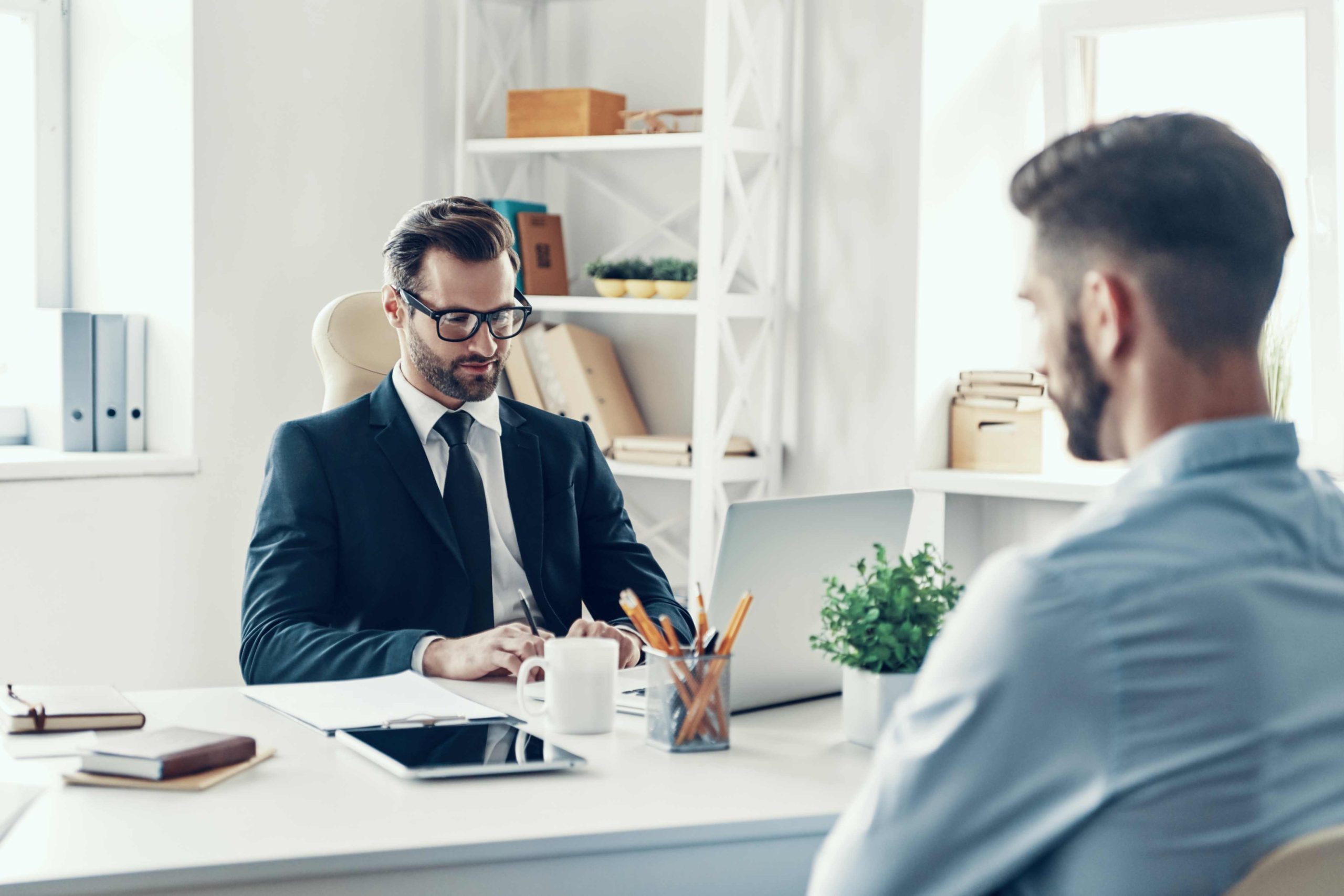 jpeg optimizer two confident young men formalwear communicating together while sitting office scaled